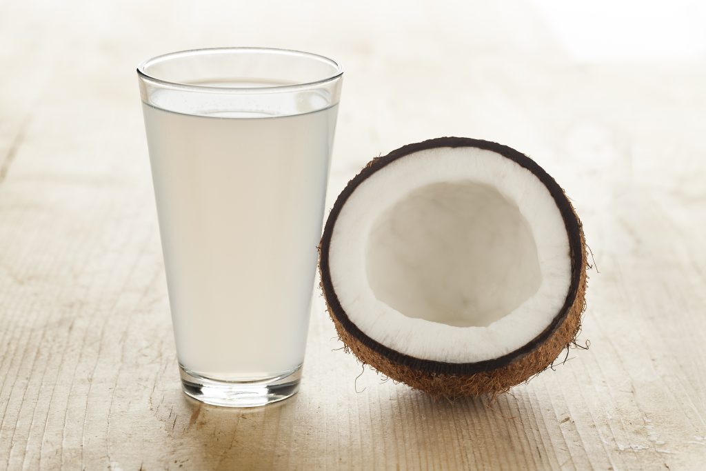 Coconut with a glass of fresh coconut water